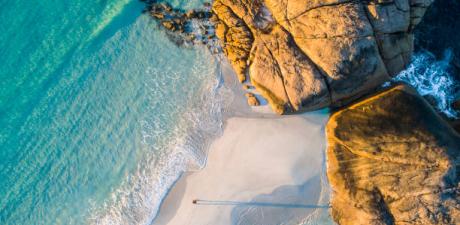a beach with waves crashing on the shore