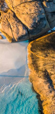 a beach with waves crashing on the shore