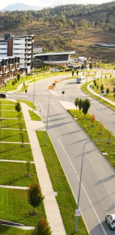 a street and buildings with cars and trees
