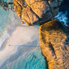 a beach with waves crashing on the shore