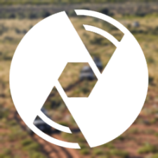 a group of vehicles driving through a field